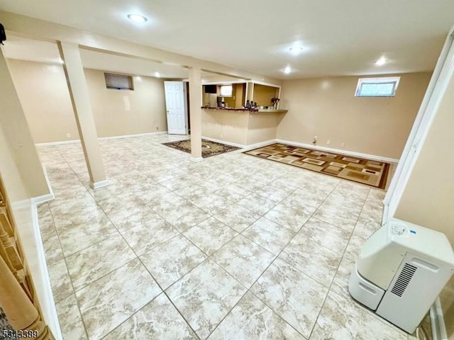 basement with recessed lighting and baseboards