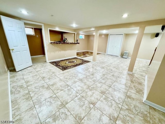 below grade area with plenty of natural light, recessed lighting, and baseboards