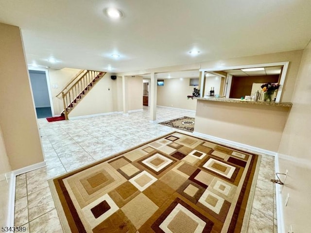 interior space featuring recessed lighting, baseboards, stairs, and freestanding refrigerator