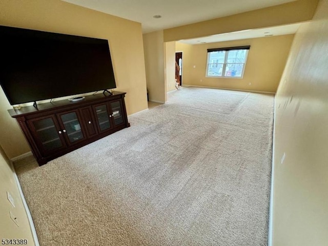 carpeted living room with baseboards