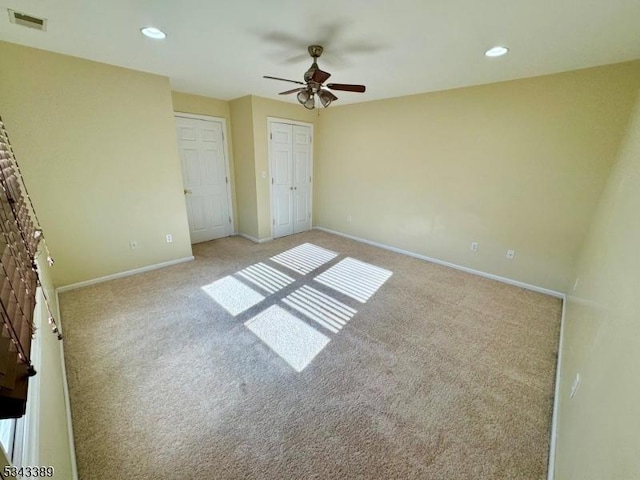 unfurnished bedroom featuring visible vents, baseboards, and carpet floors