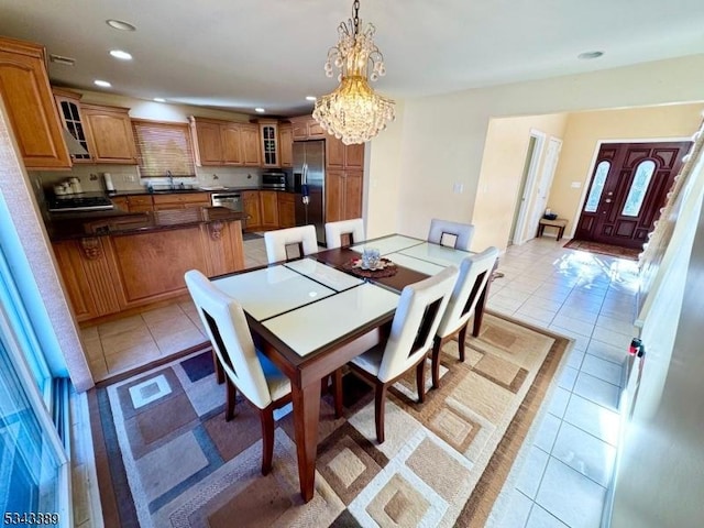 dining area featuring light tile patterned flooring, recessed lighting, and a chandelier