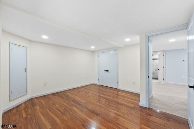 interior space featuring recessed lighting, wood finished floors, and baseboards