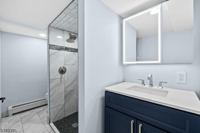 bathroom with toilet, tiled shower, vanity, and a baseboard radiator