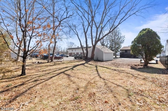 view of yard with a storage unit, an outdoor structure, and fence