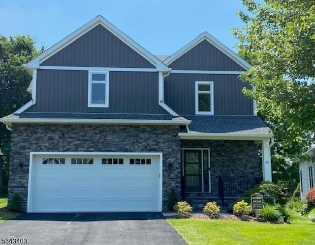 43 Bluffs Ct, Hamburg Boro, NJ 07419 - craftsman-style home featuring aphalt driveway, a front yard, roof with shingles, a garage, and stone siding