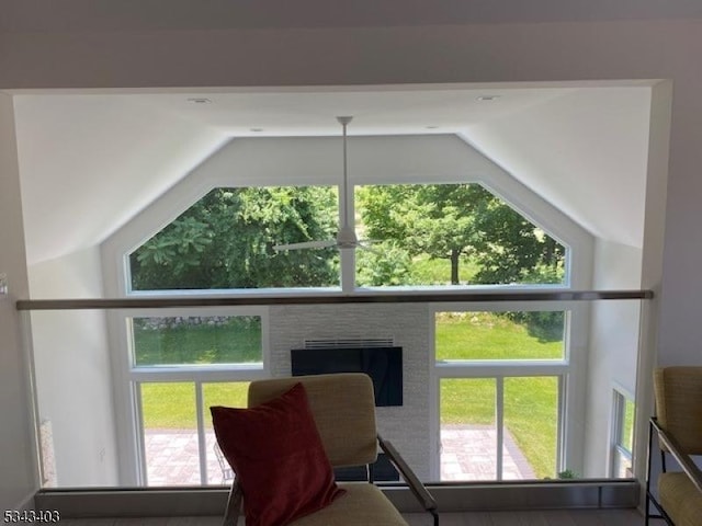 interior space with lofted ceiling and a fireplace