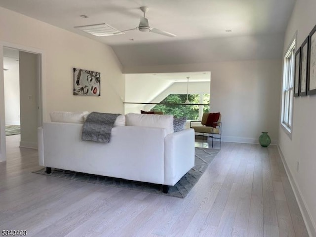 living room with vaulted ceiling, baseboards, ceiling fan, and wood finished floors