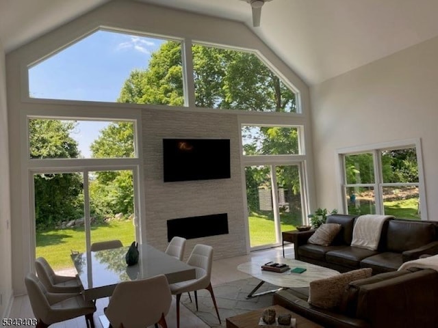 sunroom / solarium featuring a fireplace and lofted ceiling