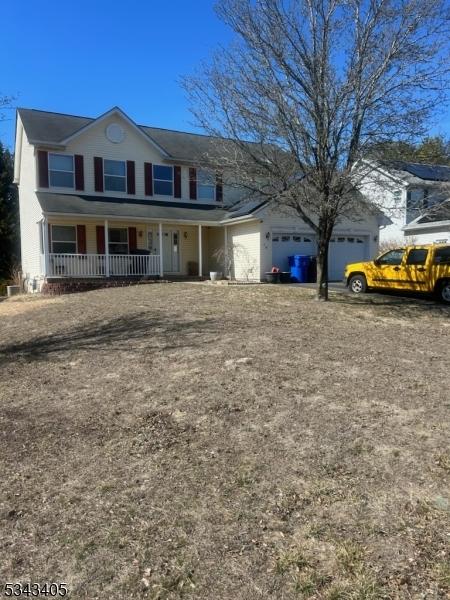 view of front of property featuring a porch and an attached garage