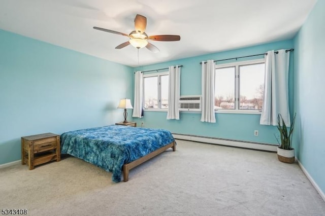 bedroom featuring a ceiling fan, baseboards, baseboard heating, and carpet floors