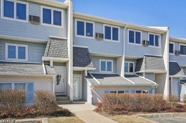 view of property featuring roof with shingles