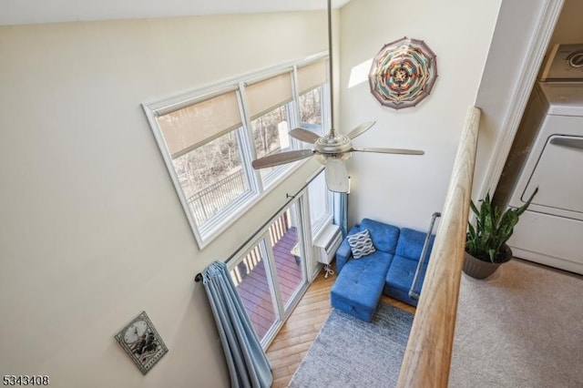 living area with washer / dryer and ceiling fan