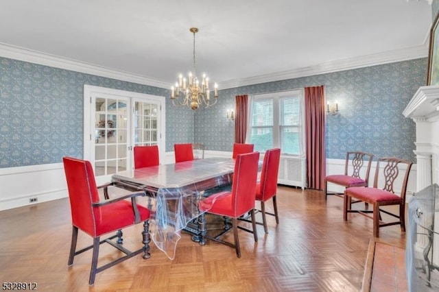 dining room with a notable chandelier, a wainscoted wall, wallpapered walls, and crown molding