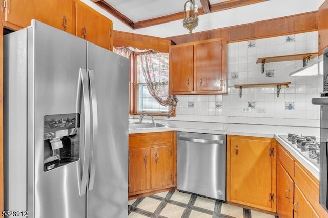 kitchen featuring light countertops, tasteful backsplash, appliances with stainless steel finishes, and a sink