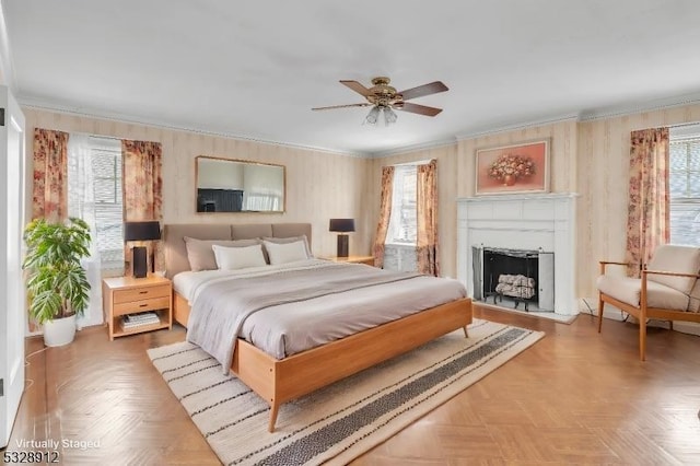 bedroom featuring multiple windows, a fireplace, and crown molding