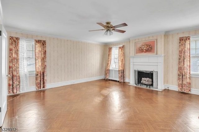 unfurnished living room featuring baseboards, plenty of natural light, ornamental molding, and a fireplace