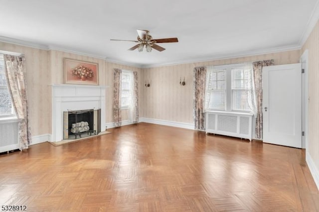 unfurnished living room featuring radiator heating unit, a healthy amount of sunlight, a fireplace with flush hearth, and ornamental molding