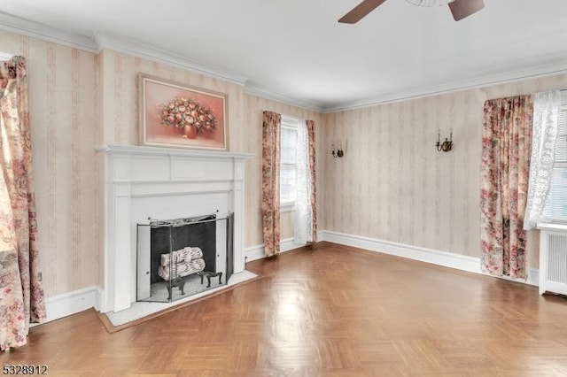 unfurnished living room featuring ornamental molding, radiator heating unit, a fireplace, baseboards, and ceiling fan