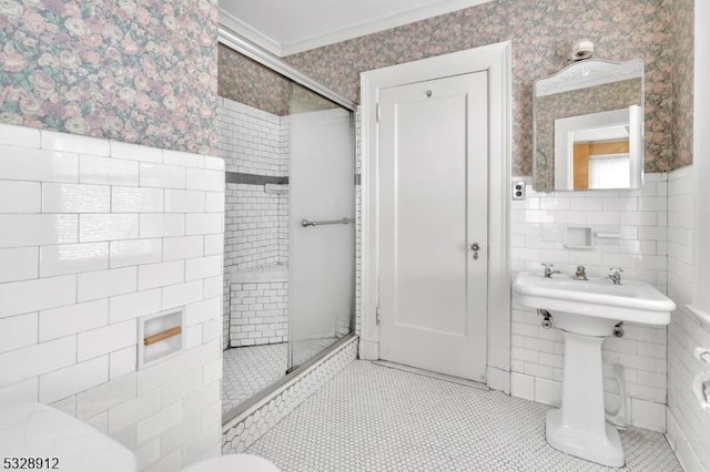 full bathroom with tile patterned flooring, tile walls, a shower stall, and wallpapered walls