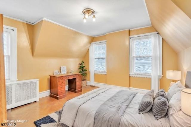 bedroom with baseboards, lofted ceiling, radiator heating unit, and crown molding