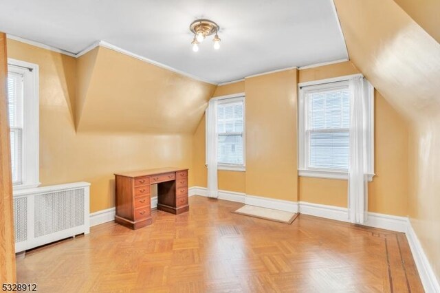 bonus room with baseboards, radiator, and lofted ceiling