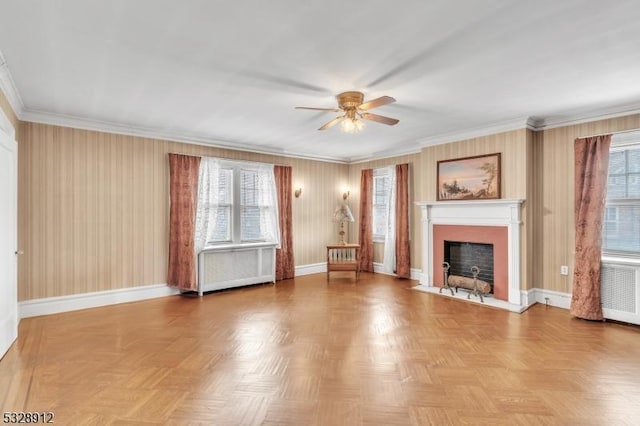 unfurnished living room with a fireplace with flush hearth, a healthy amount of sunlight, and baseboards