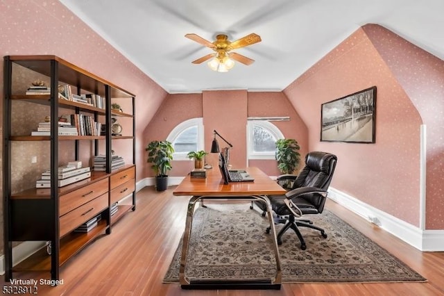 office with baseboards, wood finished floors, a ceiling fan, and vaulted ceiling