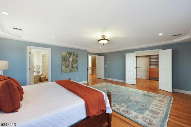 bedroom featuring recessed lighting, wood finished floors, visible vents, and baseboards