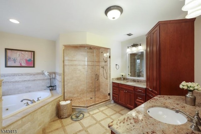 bathroom featuring visible vents, two vanities, a sink, a shower stall, and a bath