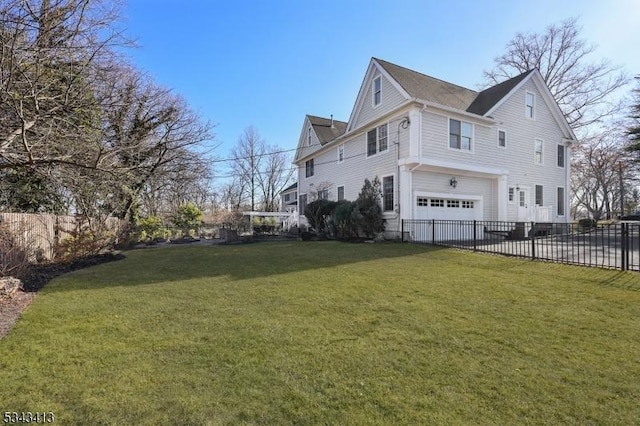 view of side of property featuring an attached garage, a lawn, and fence