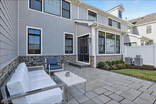 view of patio with outdoor lounge area and fence