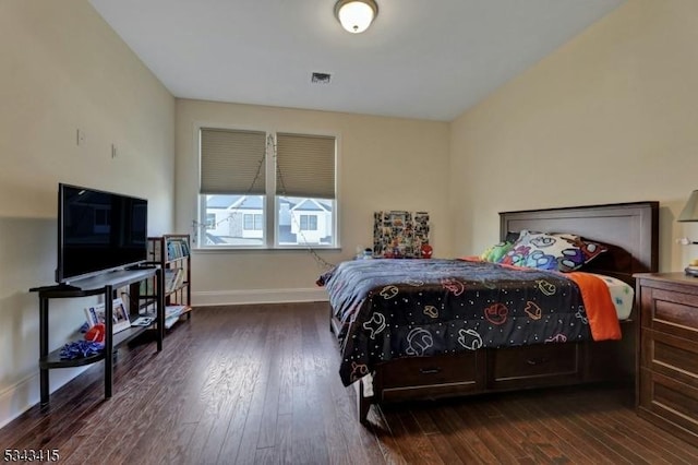 bedroom with visible vents, dark wood-type flooring, and baseboards