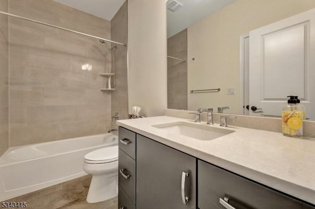 bathroom featuring vanity, shower / tub combination, toilet, and visible vents