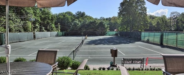 view of tennis court with fence