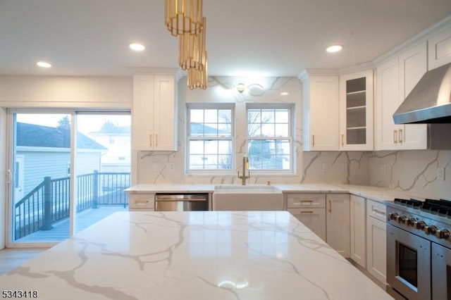 kitchen featuring light stone countertops, glass insert cabinets, appliances with stainless steel finishes, and a sink