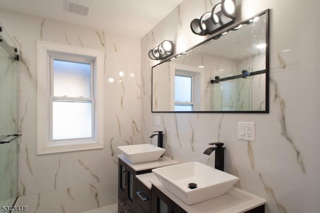 full bathroom with vanity, marble finish floor, visible vents, and a marble finish shower