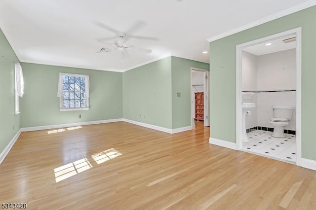 unfurnished living room featuring ornamental molding, baseboards, light wood-type flooring, and ceiling fan