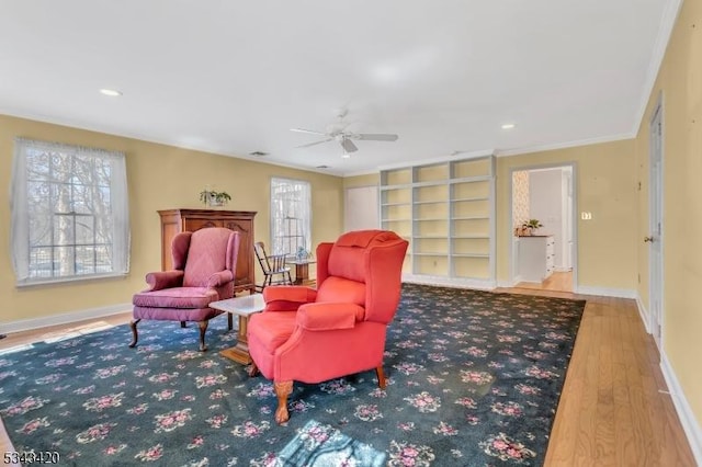 sitting room with a healthy amount of sunlight, baseboards, and ceiling fan