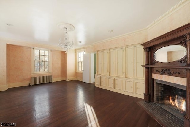 unfurnished living room with a fireplace with flush hearth, crown molding, radiator heating unit, and an inviting chandelier