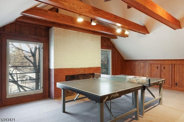 playroom featuring light carpet, wooden walls, brick wall, and lofted ceiling with beams