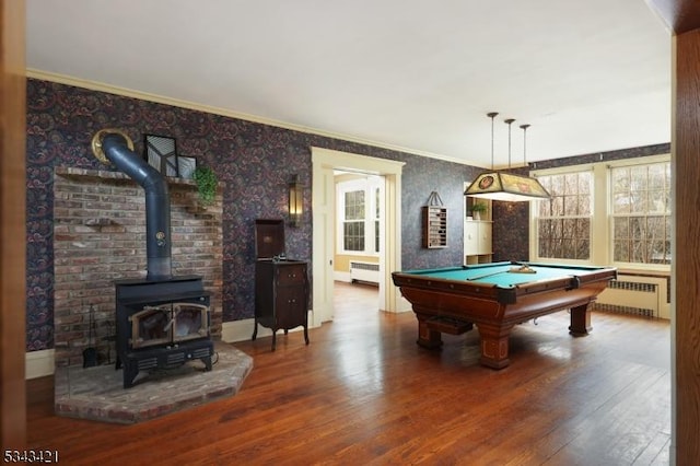 recreation room with radiator, a healthy amount of sunlight, and wood finished floors