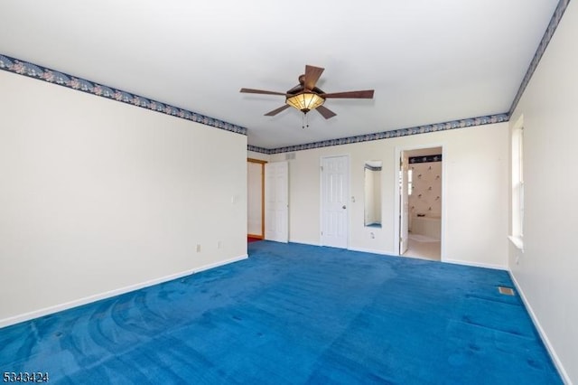 empty room featuring baseboards, a ceiling fan, and carpet