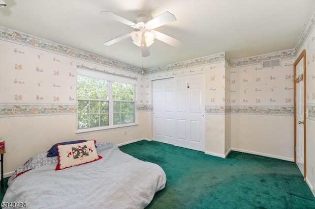 bedroom featuring wallpapered walls, dark colored carpet, baseboards, a closet, and ceiling fan