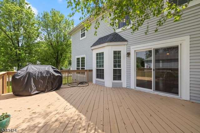 wooden deck with a grill