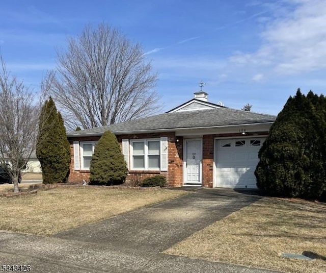 ranch-style house with brick siding, a garage, driveway, and a shingled roof