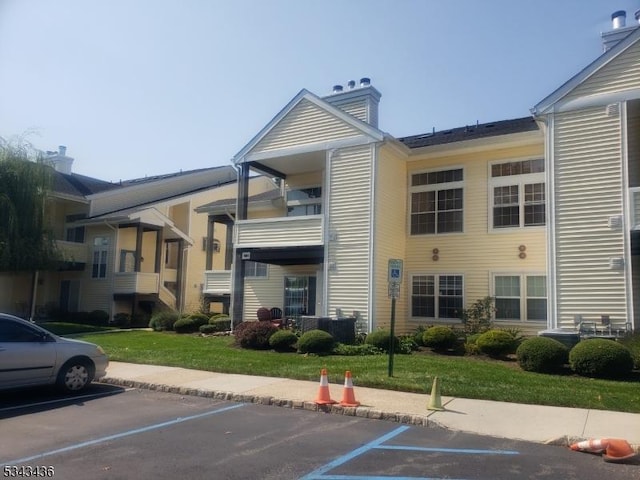 view of property featuring uncovered parking