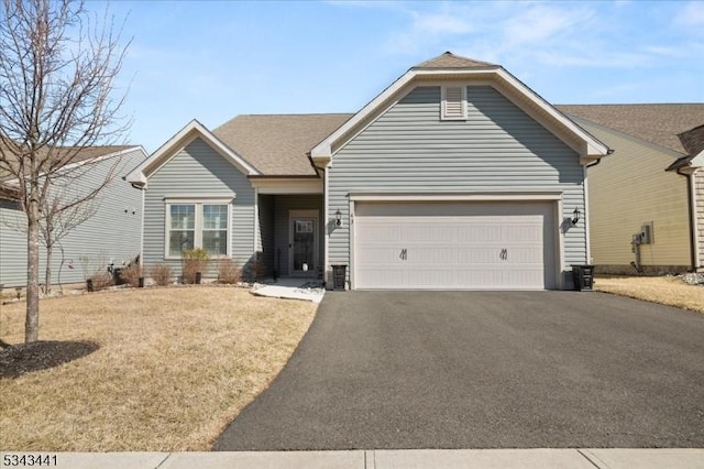 ranch-style home featuring a front yard, a garage, and driveway