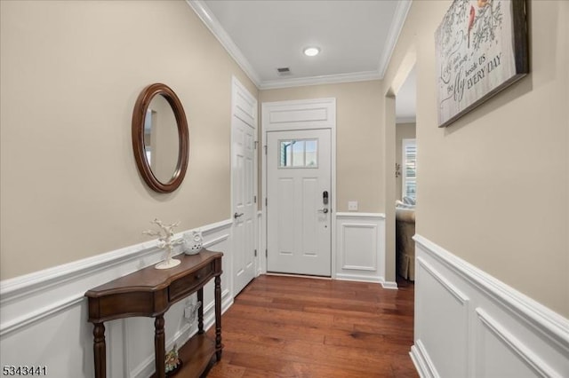 interior space with wood finished floors, a wainscoted wall, recessed lighting, ornamental molding, and a decorative wall