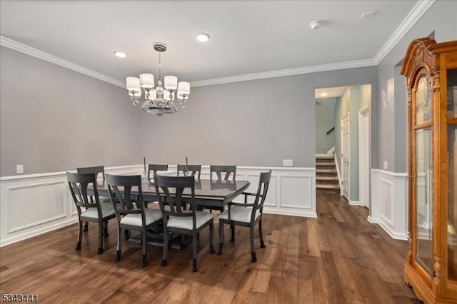 dining room featuring a chandelier, ornamental molding, stairs, and dark wood-style flooring